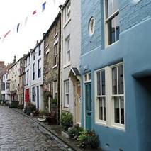 A street with row of houses

Description automatically generated